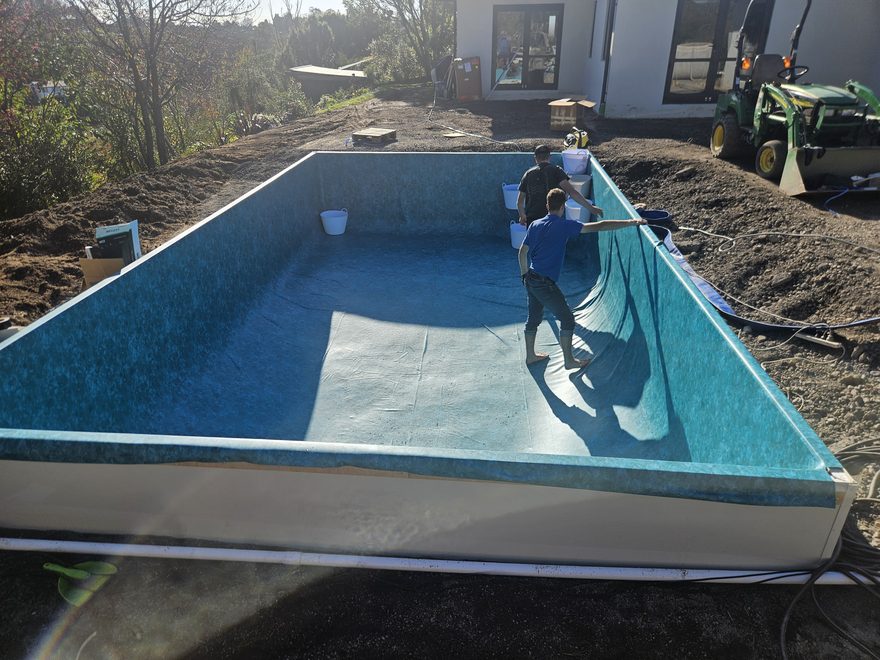 A new rectangular pool with its liner being fitted